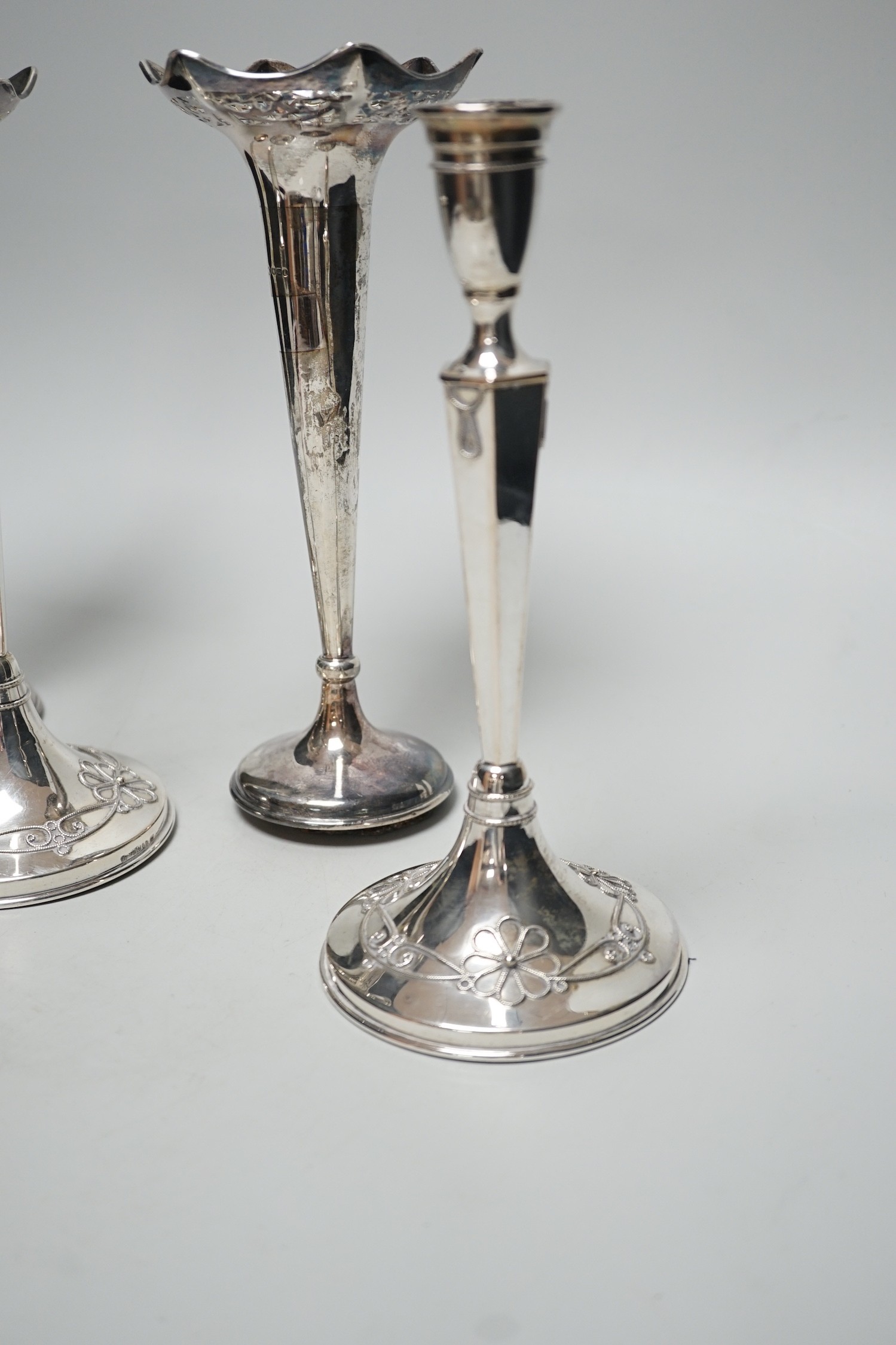 A pair of George V silver mounted posy vases, 22.3cm, weighted and a pair of German 800 standard white metal mounted candlesticks, weighted.